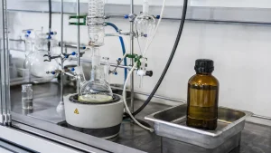 Laboratory-scale organic synthesis setup representing cinnamyl chloride used as a reactive chemical intermediate.